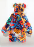 Floribunda is a magnificent, colourful one of a kind, artist teddy bear in fabulous faux fur and gorgeous mohair by Barbara-Ann Bears, he stands 19.5 inches/50 cm tall and is 15 inches/38 cm sitting. Floribunda is mostly made from a stunning piece of faux fur with a navy backing with swirls and flower motifs in gold, jade, cyan and red. His face, the fronts of his ears and the underside of his tail are made from a very long and fluffy white mohair