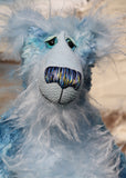 Frank Fairweather has large, beautiful, hand painted glass eyes which sparkle like jewels and have eyelids and even eyelashes! He has a carefully embroidered nose that incorporates all of his colours and a sweet, thoughtful smile. He is made from a beautiful, dense, slightly distressed mohair which Barbara has hand dyed in many gorgeous shades of the most beautiful blues. His face, tummy, the fronts of his ears and the underside of his tail are made from a very long and fluffy sky blue mohair 
