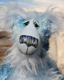  Frank Fairweather has large, beautiful, hand painted glass eyes which sparkle like jewels and have eyelids and even eyelashes! He has a carefully embroidered nose that incorporates all of his colours and a sweet, thoughtful smile. He is made from a beautiful, dense, slightly distressed mohair which Barbara has hand dyed in many gorgeous shades of the most beautiful blues. His face, tummy, the fronts of his ears and the underside of his tail are made from a very long and fluffy sky blue mohair 