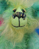 Freddo is a wonderfully happy and gorgeously green, one of a kind artist teddy bear by Barbara-Ann Bears in long and fluffy hand dyed mohair, he stands just 7.5 inches( 19 cm) tall and is 5.5 inches ( 14 cm) sitting.  Freddo is mostly made from a long distressed tousled mohair dyed jade, lime, emerald and bottle green