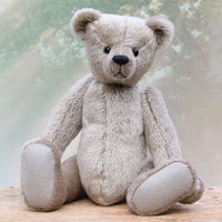 Frederick is a very sweet and cuddly, traditional teddy bear by Barbara Ann Bears, he stands 15.5 inches (39cm) tall and is 11.5 inches (29cm) sitting. Frederick is made from a silvery-grey German mohair with a straight, fairly short pile and a soft brown backing he has grey wool felt paws and vintage boot buttons eyes