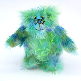 Froggy is a very happy little teddy bear, a colourful one of a kind, hand dyed mohair artist bear by Barbara-Ann Bears, he stands just 7 inches/18 cm tall and is 5.5 inches/14 cm sitting. Froggy is mostly made from a slightly sparse fluffy mohair that Barbara has hand dyed in sky blue, royal blue and grass green. Froggy has beautiful, hand painted eyes with hand coloured eyelids, a splendid nose embroidered from individual threads to compliment his colouring and he has a sweet, friendly smile