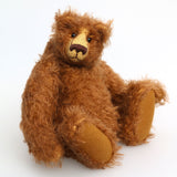 Garth is a very sweet and cuddly, artist teddy bear by Barbara Ann Bears in wonderful chocolate brown mohair, he stands 11 inches/28 cm tall and is 8.5 inches/21 cm sitting. Garth is made from a beautiful, slightly distressed brown German mohair with matching German wool-felt paw pads and small amber glass eyes