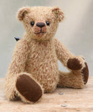 George is a very sweet and cuddly little teddy bear with an innocent childlike charm. He's a bear for cakes and hugs, a sweet face smiling at you when life hasn't been so kind. George is made from short, sparse blonde German mohair which has a warm tan backing. George has brown wool felt paw pads and vintage boot buttons for eyes. He has a carefully embroidered little nose and the sweetest smile. He is stuffed with polyester stuffing and plastic pellets, which gives him a more cuddly and soft feel.