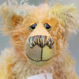 Gregory is made from a fairly long wispy mohair that Barbara has dyed in soft shades of jade, peach, grey and yellow . Gregory has hand dyed velvet paw pads which coordinate very well with his main colours.  Gregory has beautiful, hand painted glass eyes with hand coloured eyelids, a splendid nose embroidered from individual threads to compliment his colouring and he has a huge, friendly smile
