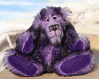 Griswald Grooch is made from a straight pile, medium length, black-tipped purple mohair that on a little bear seems quite long and fluffy. Griswald has purple velvet paw pads which complement his mohair beautifully and have a slight sparkle.  Griswald Grooch has beautiful, hand painted eyes with hand coloured eyelids, a splendid little nose embroidered from individual threads to match his colouring and he has a sweet, friendly expression