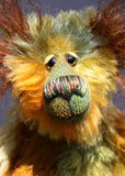 Grunyan has beautiful, hand painted eyes with hand coloured eyelids, a splendid nose embroidered from individual threads to complement his colouring and he has a sweet, friendly smile . The fronts of his ears and the underside of his tail are made from a very long and fluffy brown mohair. Grunyan loves his fluffy ears, he says they help him hear the song of distant nightingales...and the gentle sound of a large cake being sliced into (generously sized) pieces