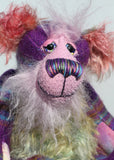 His face is a very, long and fluffy pale pink mohair and his tummy, the underside of his tail and the fronts of his ears are a fairly long distressed mohair dyed in subtle shades of green, blue and dusky pink. Harry Huckleberry has beautiful hand painted glass eyes with hand painted eyelids, a wonderfully embroidered nose, sewn from individual threads to match his colouring, he has a rather reflective expression and a huge beaming smile