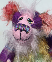 His face is a very, long and fluffy pale pink mohair and his tummy, the underside of his tail and the fronts of his ears are a fairly long distressed mohair dyed in subtle shades of green, blue and dusky pink. Harry Huckleberry has beautiful hand painted glass eyes with hand painted eyelids, a wonderfully embroidered nose, sewn from individual threads to match his colouring, he has a rather reflective expression and a huge beaming smile