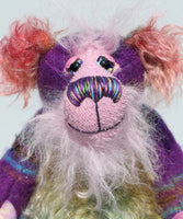 His face is a very, long and fluffy pale pink mohair and his tummy, the underside of his tail and the fronts of his ears are a fairly long distressed mohair dyed in subtle shades of green, blue and dusky pink.  Harry Huckleberry has beautiful hand painted glass eyes with hand painted eyelids, a wonderfully embroidered nose, sewn from individual threads to match his colouring, he has a rather reflective expression and a huge beaming smile