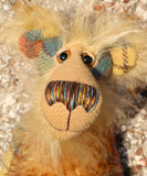 Howard Huckleford is made from a beautifully coloured Harris Tweed and a long, fluffy brown tipped blonde mohair with beige German wool felt paw pads  Howard Huckleford has large, beautiful, hand painted glass eyes (painted to match his colours) with hand coloured eyelids, an impressive nose embroidered from individual threads to match his colouring and a beaming smile