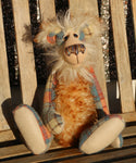 Howard Huckleford is made from a beautifully coloured Harris Tweed and a long, fluffy brown tipped blonde mohair with beige German wool felt paw pads  Howard Huckleford has large, beautiful, hand painted glass eyes (painted to match his colours) with hand coloured eyelids, an impressive nose embroidered from individual threads to match his colouring and a beaming smile