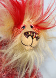 Humphrey Huffleton has beautiful, hand painted eyes with hand coloured eyelids, a splendid nose embroidered from individual threads to compliment his colouring and he has a huge, friendly smile. His face and the fronts of his ears are a long wispy blonde mohair and the top of his head is a long bright red faux fur
