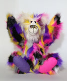 Miguel is made from a long and dense faux fur in black, magenta, yellow, violet, grey and white. Miguel 's face, the fronts of his ears and the underside of his tail are made from a very long and soft white mohair. Miguel's felt paw pads are in four different colours to tie all his colours together, you can see in this photo waving his paws in the air.  Miguel has large, beautiful, hand painted glass eyes with hand coloured eyelids, he has a carefully embroidered nose to match his colours and a sweet smile