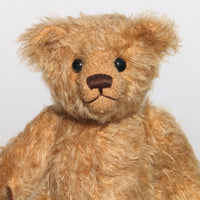 Jack is made from beautiful, slightly distressed antique gold German mohair, he has brown wool-felt paw pads and vintage boot buttons for eyes. He has a carefully embroidered little nose and the sweetest smile