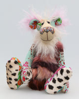 Jackie O'Kapi is a kooky, funky and funny one of a kind artist bear in printed cotton, mohair and faux fur by Barbara Ann Bears, he stands 14.5 inches( 37 cm) tall and is 11.5 inches (29 cm) sitting. Jackie O'Kapi is quite a gangly, comical bear, he's a bear who wants to see you smiling and even laughing.