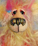 Jeremy Pootles has beautiful, hand painted eyes with hand coloured eyelids, a splendid nose embroidered from individual threads to compliment his colouring and he has a sweet, friendly smile. On top of Jeremy's head there is a plume of long faux fur in blue, pink and yellow