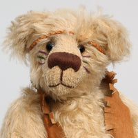 Jericho Joe is a youthful, playful teddy bear who likes to play and dress up, a veteran artist bear from Barbara-Ann Bears from the 1990s, he stands 12 inches (30 cm) tall and is 9 inches (23 cm) sitting. He was made from a pale beige German mohair, he has beige wool felt paw pads and pale amber translucent glass eyes
