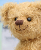 Josh is made from the most wonderful, wildly curly beige gold mohair, with a slightly warmer backcloth. Josh has black boot button eyes, like the old teddy bears. He has a carefully embroidered nose and a warm beaming smile which gives him that puppy dog 'please pick me up and love me' expression