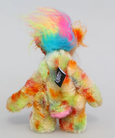 Kenny Kapow is a joyful bear of colourful happiness, a one of a kind, hand dyed mohair and faux fur artist bear by Barbara-Ann Bears, he stands 8.5 inches/21 cm tall and is 6.5 inches/16 cm sitting. He is made in multicoloured hand dyed mohair and spotty faux fur with a plume of long colourful faux fur on his head