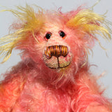 Lenny Lemonears has beautiful, hand painted eyes with hand coloured eyelids, a splendid little nose embroidered from individual threads to compliment his colouring and he has a sweet, friendly smile. Lenny Lemonears is nearly entirely made from a wildly tousled mohair which Andy dyed in soft pinks, gold and magenta, while the fronts of his ears and the underside of his tail are a long, fluffy mohair hand-dyed a lemony yellow
