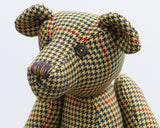 Lewis has one glass eye and the other eye is a button from the tweed jacket he was made from. Lewis has a marvellous multicoloured nose, stitched from individual threads that were chosen to match his colouring and Lewis has a sweet, thoughtful expression