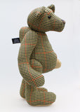 Lewis is a an elegant and refined traditional Barbara Ann Bear,he stands 17 inches (43cm) tall and is 12 inches (30cm) sitting. Lewis is made from a beautiful strong tweed, it's a check pattern in beige, olive green, cinnamon, navy blue and antique gold, with dull khaki wool felt paw pads