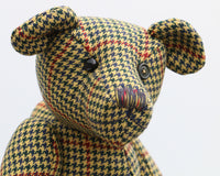 Lewis has one glass eye and the other eye is a button from the tweed jacket he was made from. Lewis has a marvellous multicoloured nose, stitched from individual threads that were chosen to match his colouring and Lewis has a sweet, thoughtful expression
