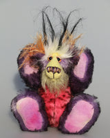 Lickle Pickle is a small, cute and very happy one of a kind mohair artist teddy bear by Barbara-Ann Bears Lickle Pickle is made from a black-tipped purple mohair, sunny yellow and soft orange mohair soft pink faux fur with black splodges and a soft white faux fur with long plumes of black faux fur sprout like fireworks