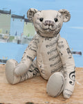 Ludwig is a an elegant and cultured traditional Barbara Ann Bear, he is 16 inches (38cm) tall and is 11 inches (30cm) sitting. Ludwig is made from a pale grey upholstery fabric with areas of beige over which musical phrases have been printed, he has pale grey wool felt paw pads and vintage shoe buttons for eyes