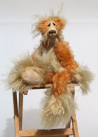 Macadamia is a marvellous, charming and elegant, one of a kind, mohair artist bear by Barbara-Ann Bears, he is 13.5 inches(34 cm) tall from his toes to his head and is 9 inches (23 cm) sitting from his bottom to his head, he has flexible knees and bent legs so he can't stand up, he just sits rather elegantly.