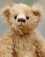 Matthew is a charming and traditional mohair artist bear by Barbara Ann Bears of the same design as the teddy bear we made for Downton Abbey.  He stands 10.5 inches/27 cm tall and is 8.5 inches/22 cm sitting and is made from  beautiful, wavy, fairly long beige coloured German mohair