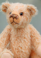 Maureen is a charming and traditional mohair artist bear by Barbara Ann Bears in beautiful pale peach coloured German mohair, stands 10 inches/25 cm tall and is 7.5 inches/18 cm sitting. She likes to think that she's a bit different from the other bears as she has a multicoloured nose and hand painted glass eyes