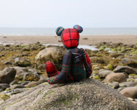 McTavish is our first Scottish tartan bear, a calm and elegant fellow in a striking mixture of pattern and colour. A bear who is as happy on a comfortable shelf as he is walking the moors or sitting on a windswept beach and above all a teddy bear who is always ready for a cuddle. 