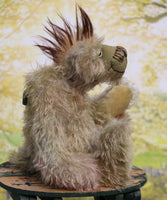 Melvin is an endearingly sweet and gentle, beautifully coloured, one of a kind, hand dyed mohair artist bear by Barbara-Ann Bears. Melvin stands 12 inches( 30 cm) tall and is 8.5 inches (21 cm) sitting with a 2.5 inch (6 cm) long mohawk. He's mostly made from a medium length hand dyed mohair, in a subtle blend of greens,