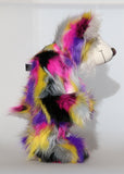 Miguel is mostly made from a very long, shaggy and dense faux fur which is black with bands of magenta, yellow, violet, grey and white. Miguel 's face, the fronts of his ears and the underside of his tail are made from a very long and soft white mohair. Miguel has large, beautiful, hand painted glass eyes with hand coloured eyelids, he has a carefully embroidered nose that incorporates all of his colours and a sweet, thoughtful smile