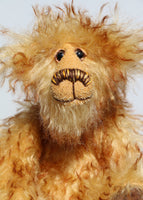Milo is made from a sumptuous, long, very dense, soft and twirly, brown tipped gold mohair. Milo has beautiful hand painted, twinkling, glass eyes with hand coloured eyelids, a splendid nose embroidered from individual threads that tie in with his colours and a happy, hopeful expression, the sort of expression that seems to be asking for a big hug (or it could be cake).