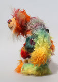 Morrison is a beautifully coloured, bright and cheerful, one of a kind, hand dyed mohair and faux fur artist bear by Barbara-Ann Bears, he stands 12 inches( 30 cm) tall and is 8.5 inches (21 cm) sitting. Morrison is mostly made from a piece of long, wildly tousled hand dyed mohair dyed in bands of colour like a rainbow