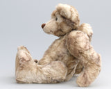 Mouldy is an endearingly sweet and loving one of a kind, artist bear by Barbara-Ann Bears, he stands 10.5 inches (236 cm) tall and is 8 inches (20 cm) sitting. Mouldy is made from soft creamy white faux fur which is subtly banded with streaks of brown, like marble but very much softer. Mouldy has beige wool-felt paws