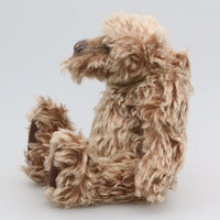Ormanroyd is a gruff and groovy guy, a veteran artist bear from Barbara-Ann Bears he stands 11.5 inches (29cm) tall and is 8.5 inches (21cm) sitting Ormanroyd was made from beautiful, dense, distressed beige-tipped brown German 'Zotty' mohair. He has brown German wool felt paw pads and green translucent glass eyes