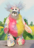 Pascual is made from printed fabric, the base colour is almost white, on top of this there are many flowers in blues, pinks, yellows and greens. His tummy is a long and fluffy faux fur in pink and yellow, his face is a very long and fluffy white mohair and the fronts of his ears and the underside of his tail are a very long and fluffy powder blue mohair. Pascual has beautiful hand painted glass eyes with eyelids, a wonderfully embroidered nose and a beaming smile