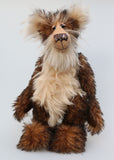 Philoneus Tomsk is a very handsome and dignified, one of a kind, artist bear by Barbara-Ann Bears, he stands 17.5 inches(45 cm) tall and is 13 inches(33 cm) sitting. He is made a long and fluffy, tousled, medium brown mohair with black tipping, contrasting with a fluffy pale cream mohair with a warmer beige backcloth