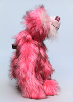 Pink Plink Fizz is an exceedingly cuddly, pink and fluffy, one of a kind, artist bear by Barbara-Ann Bears in luxurious mohair and faux fur, he stands 15 inches (38 cm) tall and is 12 inches (30 cm) sitting. He is made from a long, dense and soft faux fur which is a very strong pink with subtle black tipping. 