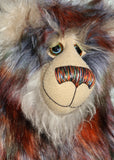 Rustus McCafferty is made from long, silky faux fur in black, white, terracotta and green, with long white mohair used on his face and the fronts of his ears, he has large, beautiful, hand painted glass eyes with hand coloured eyelids, he has a carefully embroidered nose that incorporates all of his colours and a sweet, thoughtful smile
