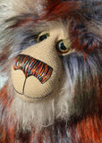 Rustus McCafferty is made from long, silky faux fur in black, white, terracotta and green, with long white mohair used on his face and the fronts of his ears, he has large, beautiful, hand painted glass eyes with hand coloured eyelids, he has a carefully embroidered nose that incorporates all of his colours and a sweet, thoughtful smile
