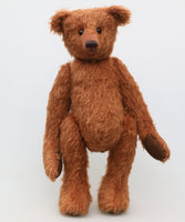 Rusty McPherson is an elegant and charming, one of a kind, traditional mohair artist teddy bear by Barbara Ann Bears, he stands 16 inches/41cm tall and is 11 inches/28 cm sitting. He is made from a medium length ginger-brown German mohair with brown German wool-felt paw pads and boot buttons for eyes, with a carefully embroidered nose and a sweet smile.