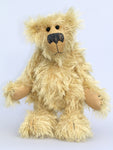 Scraggly Scratchit is a friendly, cuddly and extremely shaggy, one of a kind mohair artist bear by Barbara Ann Bears in scraggly golden mohair Scraggly Scratchit stands 13.5 inches(34 cm) tall and is 10.5 inches (26 cm) sitting.  Scraggly Scratchit is a wild and shaggy chap with a rather sad but hopeful expression