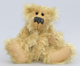 Scraggly Scratchit is a friendly, cuddly and extremely shaggy, one of a kind mohair artist bear by Barbara Ann Bears in scraggly golden mohair Scraggly Scratchit stands 13.5 inches(34 cm) tall and is 10.5 inches (26 cm) sitting.  Scraggly Scratchit is a wild and shaggy chap with a rather sad but hopeful expression