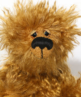 Sid Scruffball has hand painted eyes with spotty hand painted eyelids and he has a rather large nose embroidered from black soft cotton thread, large and sensitive enough to sniff out a honey filled bee's nest or a cake over ten miles away. Sid has a huge, beaming smile, although this is mostly hidden within his beard, it's a secret smile.Sid Scruffball is almost entirely made from a very long and fluffy coffee brown mohair