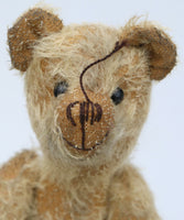 Slim Tim Tittlemouse is a scruffy and dishevelled traditional one of a kind artist bear in German mohair by Barbara Ann Bears  Slim Tim Tittlemouse is 11 inches/28 cm tall and is 7.5 inches/22 cm sitting.  Slim Tim Tittlemouse is a tribute to Little Tommy Tittlemouse who sits in the V&A Museum in London, although Slim Tim is twice the size of Little Tommy. He's been made to look very old and well loved, he might look grubby but he's a clean bear, he's just been rubbed with a soft sketching pencil. 